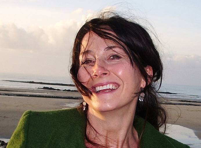 A head and shoulders photo of RLF Writing Fellow Francesca Armour-Chelu at thebeach, smiling