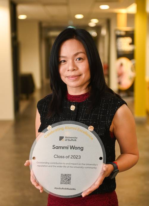 Graduate holding a plaque