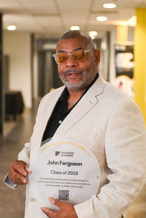 Graduate holding a plaque