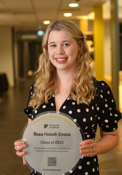 Graduate holding a plaque