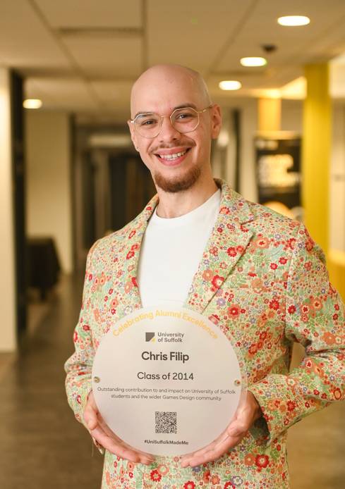 Graduate holding a plaque