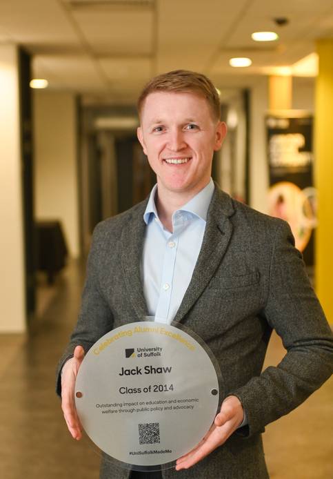 Graduate holding a plaque