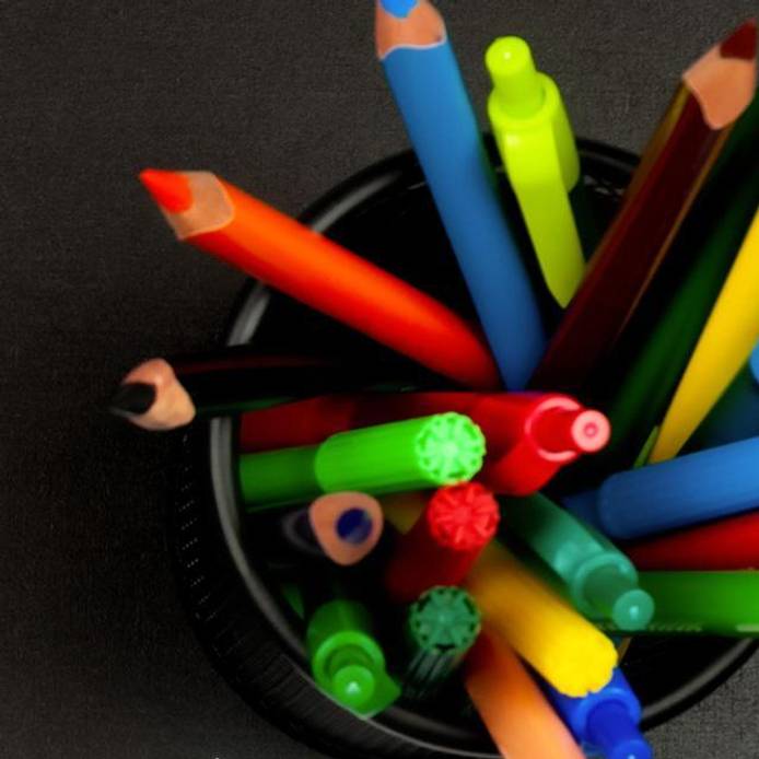 Pens and pencils in a pot