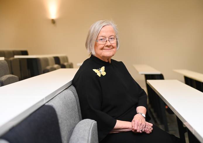 A photo of Lady Hale seated in the lecture theatre looking to the camera and smiling