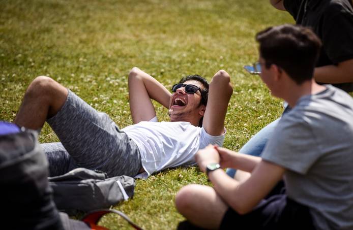 A student lying down, relaxing in a park