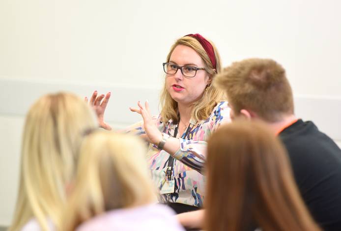 Staff member talking to students