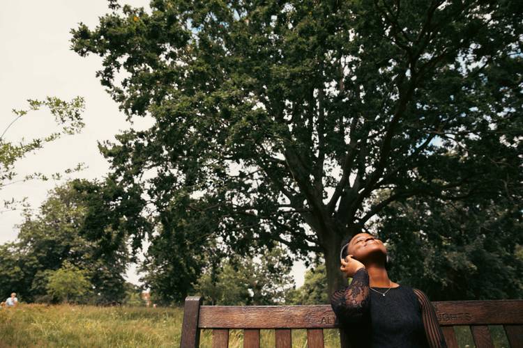 Student looking up to the sky in Christchurch Park