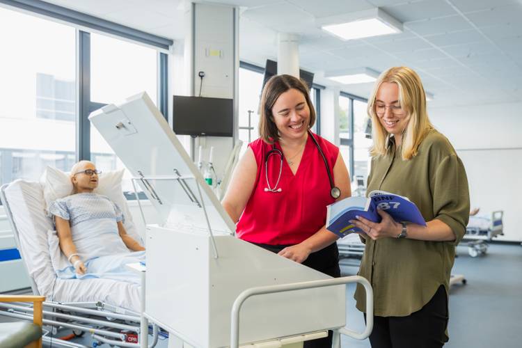 Pharmacy student in ward with pharmacy trolly