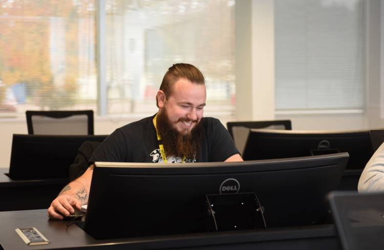 A student sitting at a desktop computer