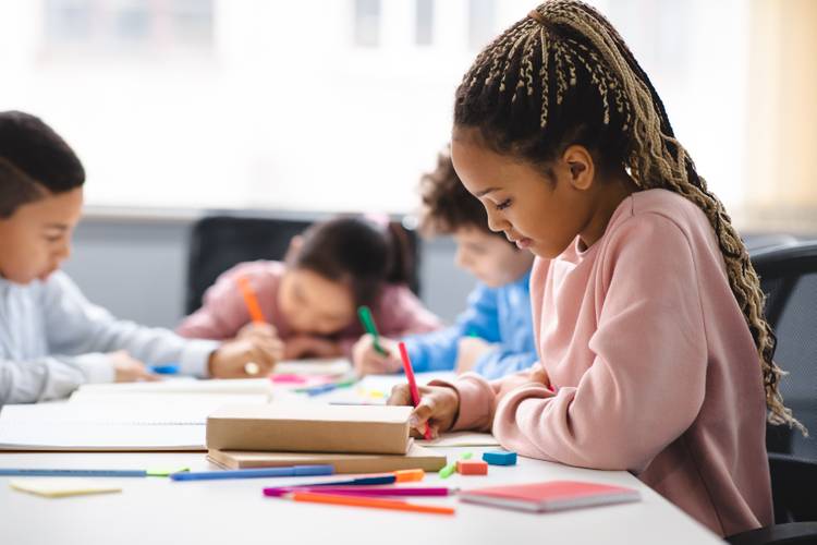 A child sitting and working in a classroom