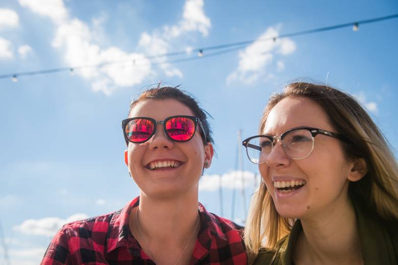 Two students smiling in the sunshine