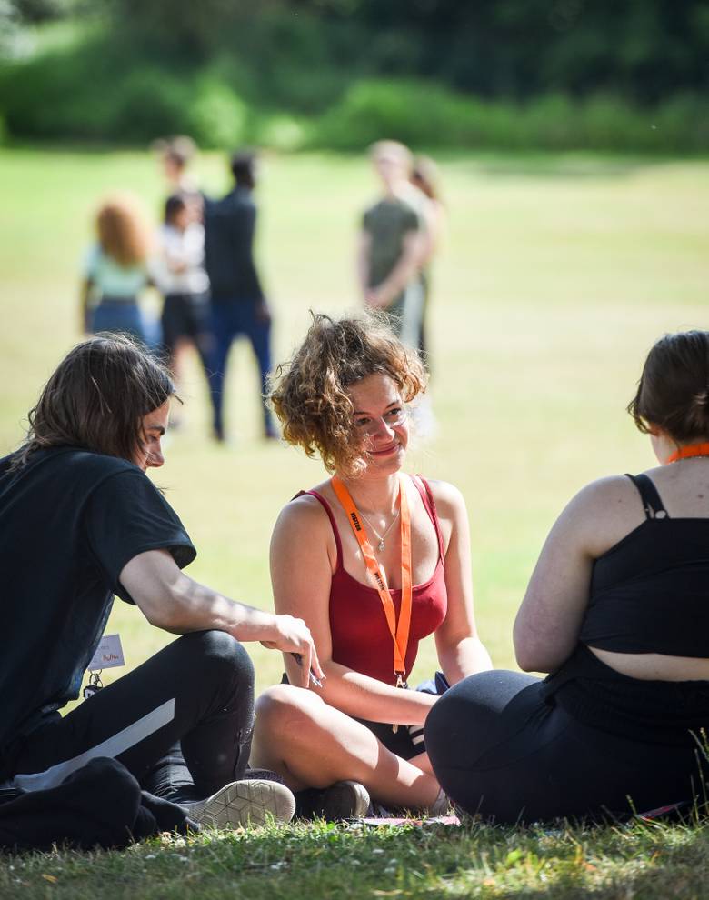 Students sitting, relaxing in a park