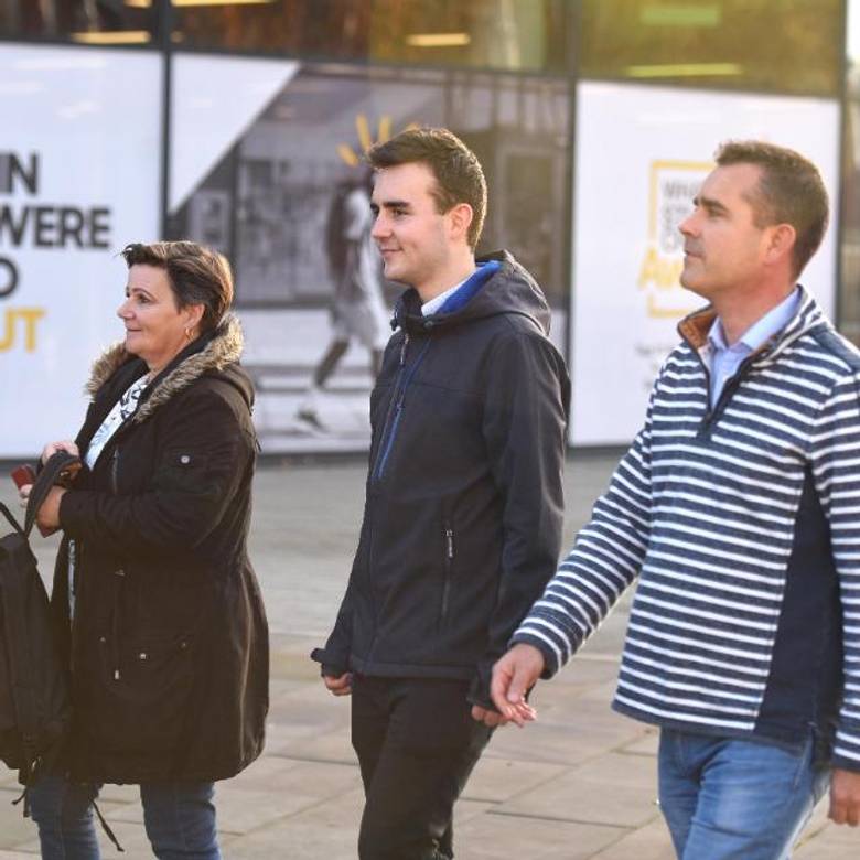Parents and student walking on campus
