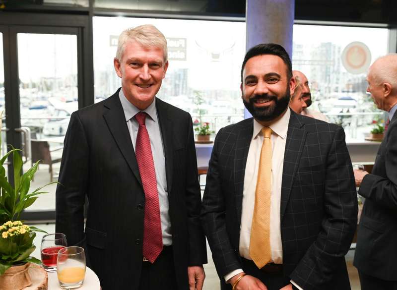 Two men smile at the Alumni Connection Week 2023 Supporters Drinks Reception