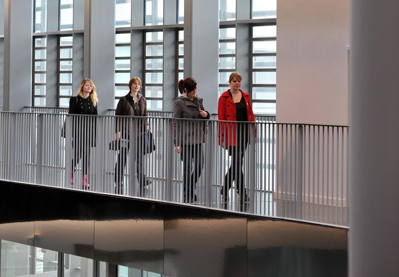 Students walking on a balcony inside Suffolk New College