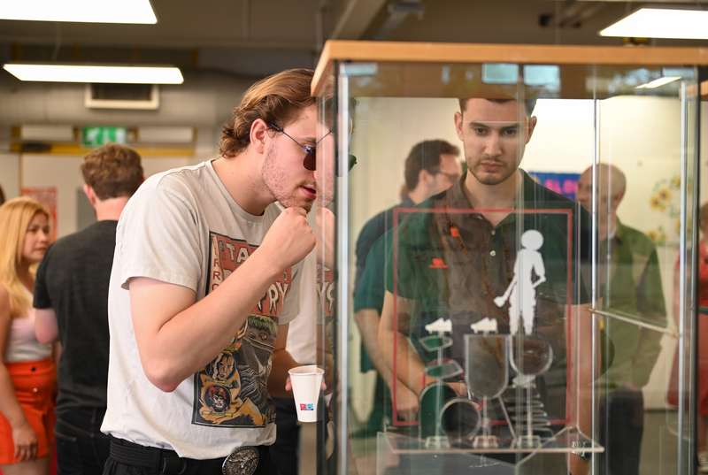 Two people viewing a display case