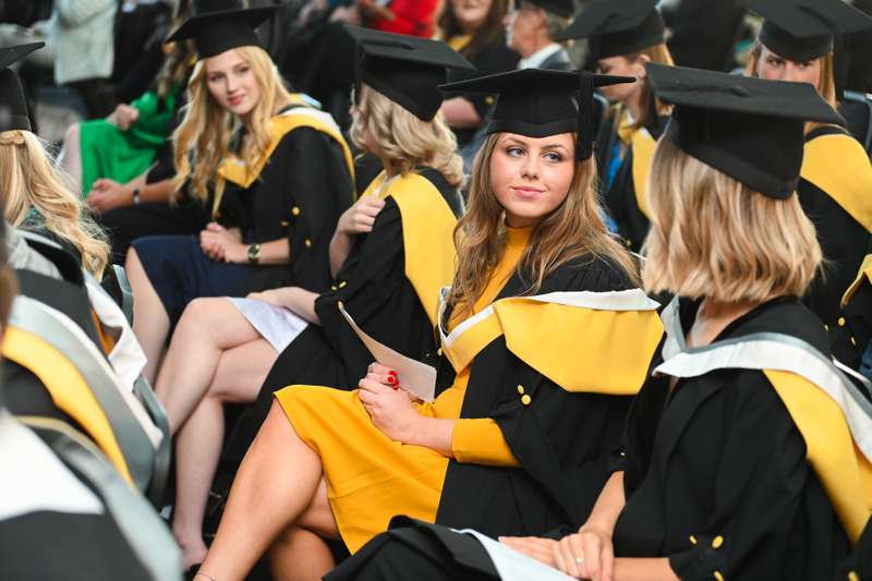 A row of students sitting in a graduation ceremony