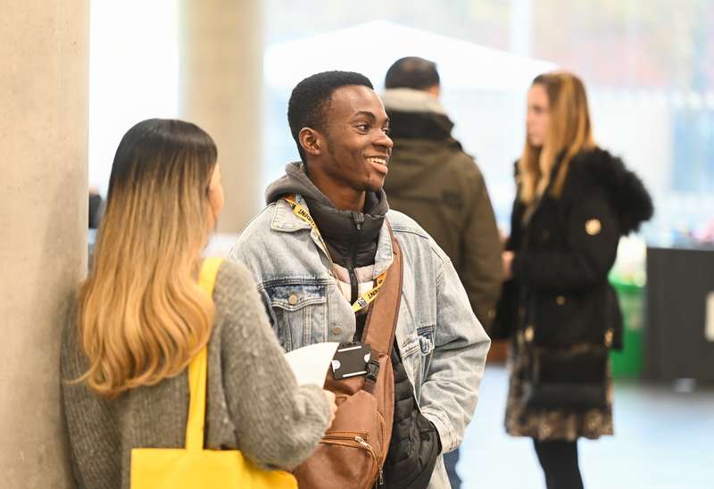 Students standing in a foyer