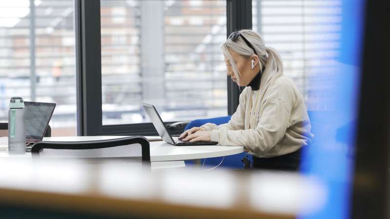 A student sitting and studying in the library