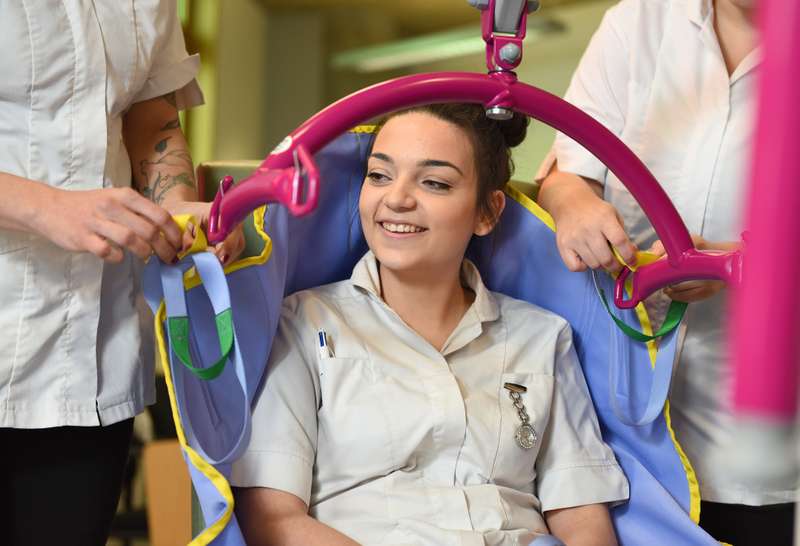 A student sitting in a hoist