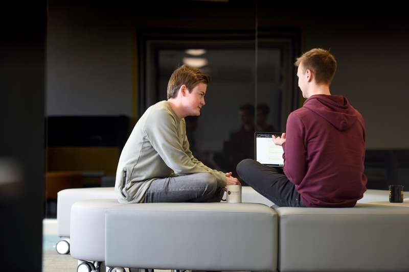 Two students sitting in the Ideas room