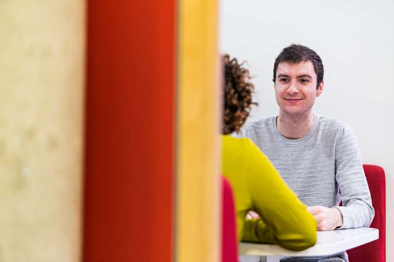 Two student sitting in a study pod