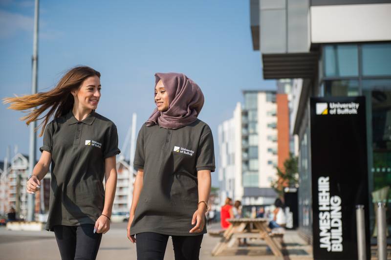 Two student ambassadors walking on the waterfront