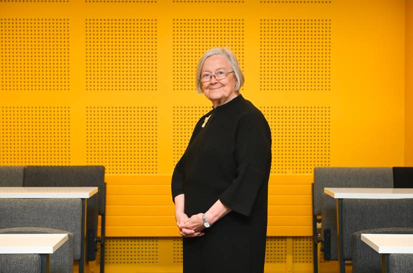 Baroness Hale against a yellow background