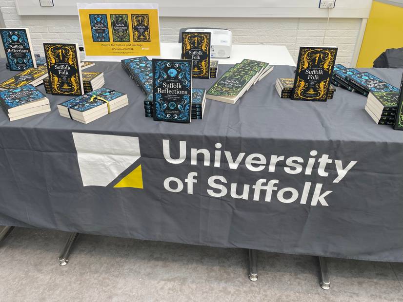 A photo of the three books, Suffolk Reflections, Suffolk Arboretum and Suffolk Folk on a display table with a Ӱ logo banner
