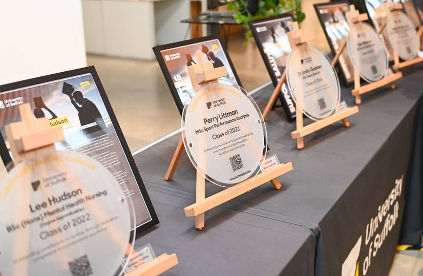 The Alumni Award plaques lined up on a table at the awards ceremony