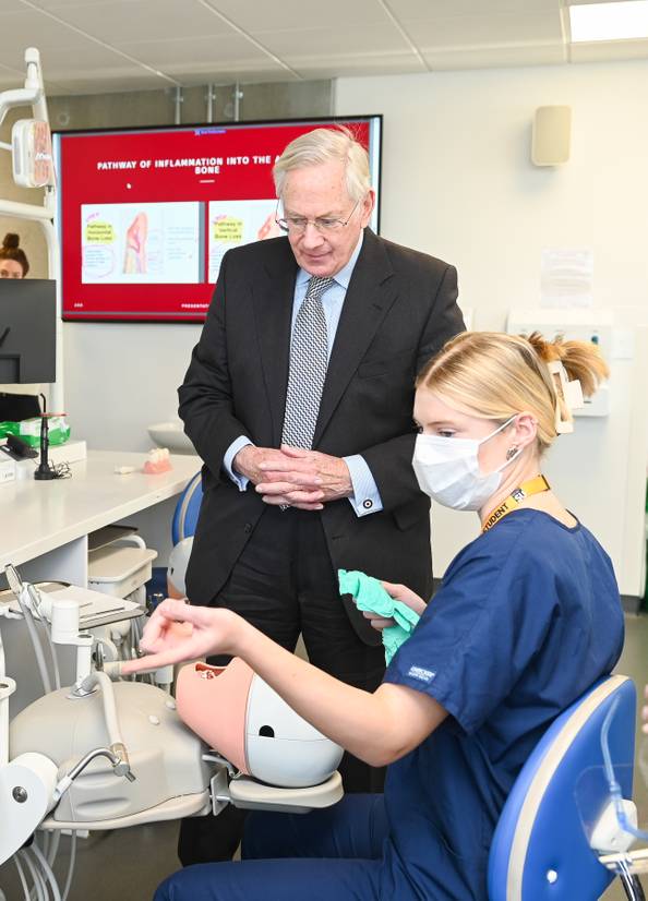 HRH The Duke of Gloucester is shown a demonstration on a phantom head by a Dental Hygiene and Therapy student