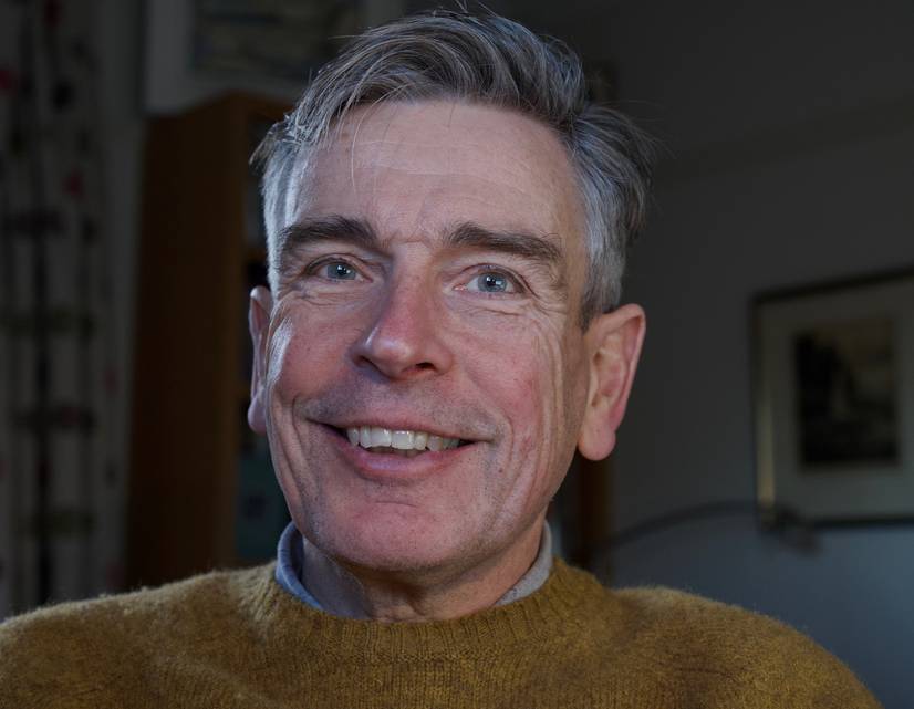 A head and shoulders photo of Visiting Professor Dr Simon Rudland, smiling
