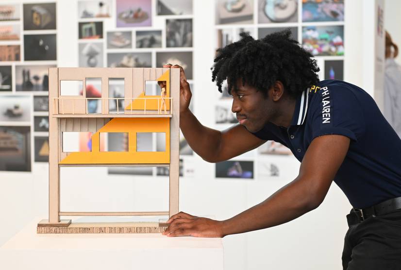 A student looking at an architectural model