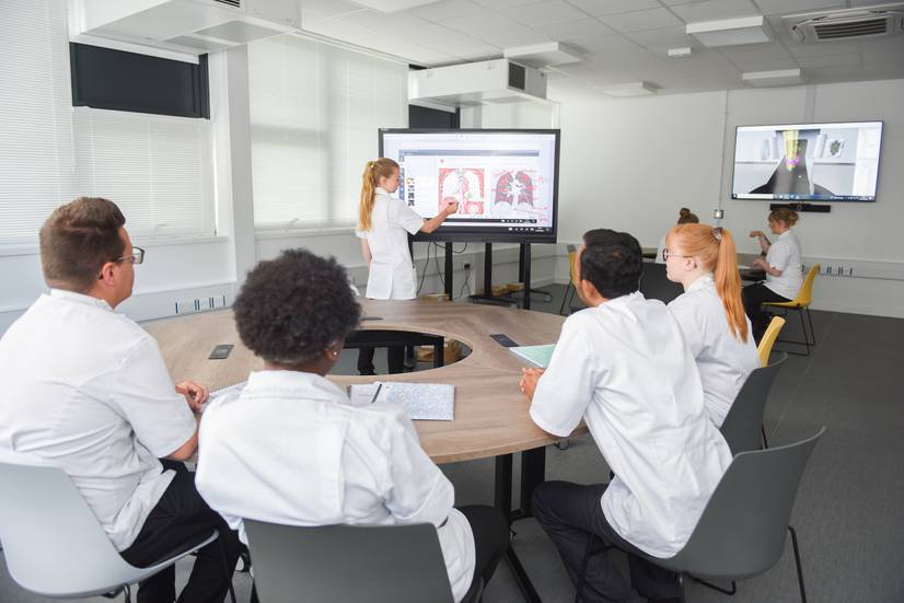 Group of students looking at diagrams on a screen