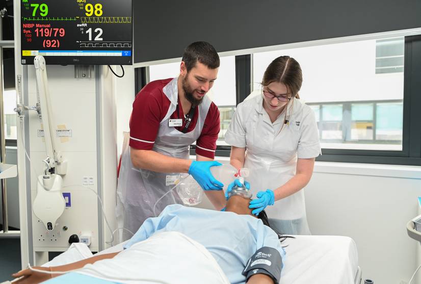 A nursing student and lecturer using a manual resuscitator bag