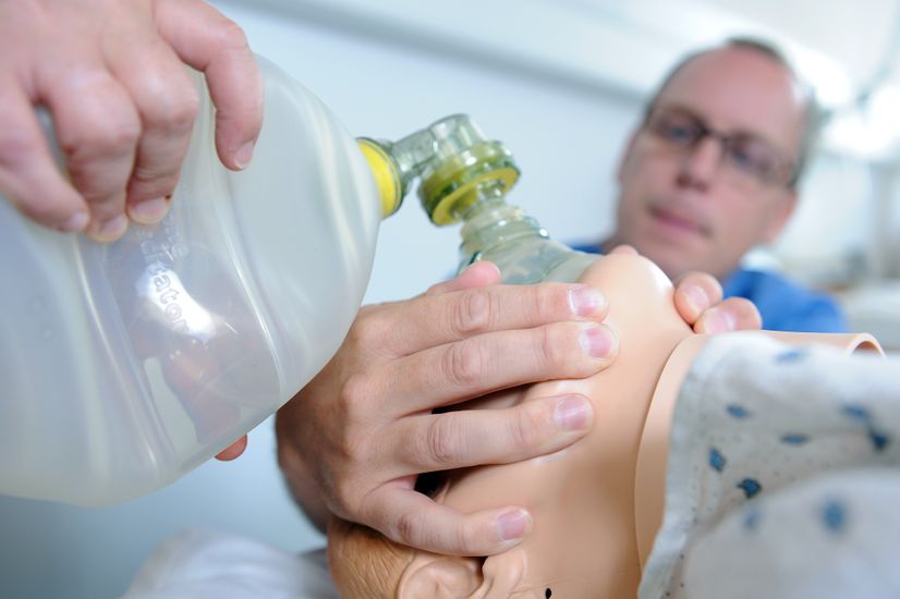 Close-up of nursing student using manual resuscitator bag